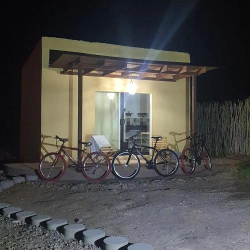 a group of bikes parked under a shed at night at Tres Velas Surf in Celestino Gasca