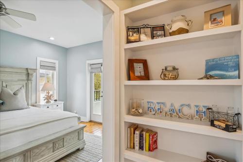 a bedroom with a bed and shelves with books at Sans Souci by 30A Escapes in Seacrest