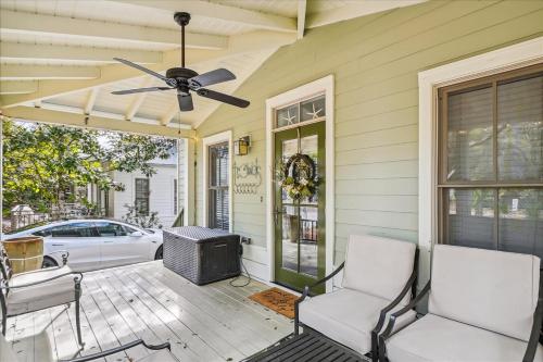 a porch with two chairs and a ceiling fan at Sans Souci by 30A Escapes in Seacrest