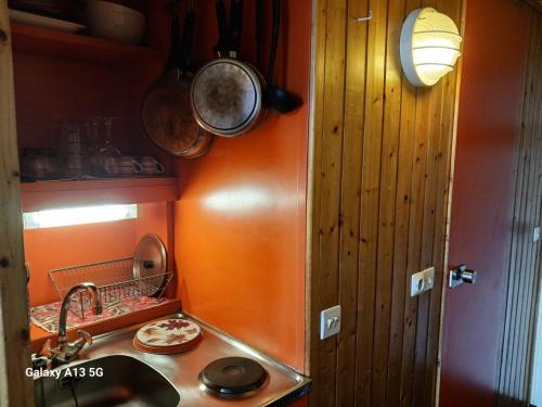 a small kitchen with a sink and a counter top at Résidence Grand Arbois - Studio pour 2 Personnes 051 in Arc 1800