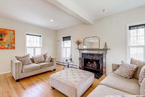 a living room with two couches and a fireplace at Mystic Retreat with Patio and Grill Walk to River! in Mystic