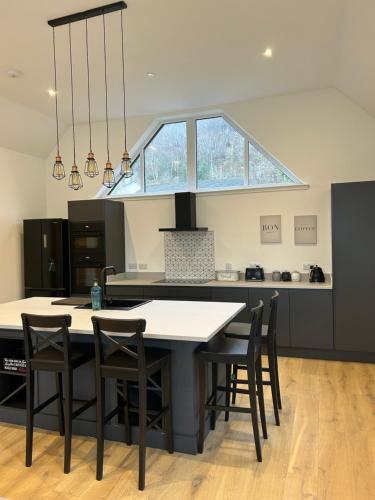 a kitchen with a table with chairs and a window at Gili Taigh in Fort William