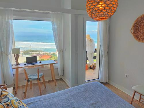 a bedroom with a bed and a desk with a laptop at Santa Cruz Ocean Apartment - I in Santa Cruz