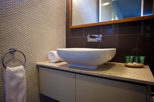 a bathroom with a large white bowl sink on a counter at Byron Luxury Beach Houses in Byron Bay
