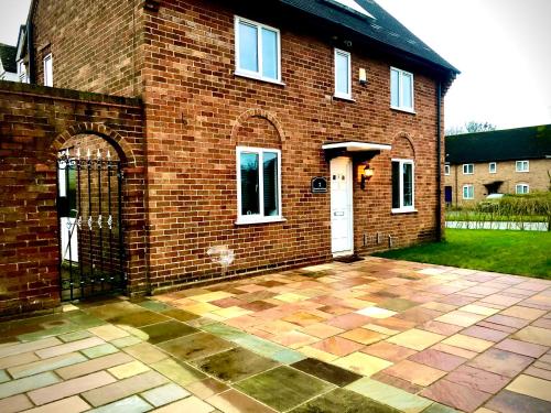 a brick house with a gate in front of it at The Highfield Chester. in Chester