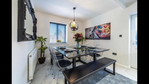 a dining room with a black table and chairs at The Highfield Chester. in Chester
