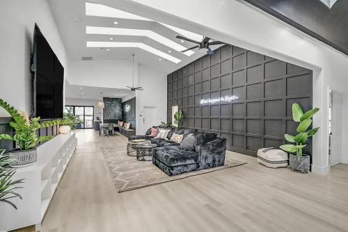 a living room with a couch and some plants at 8000sf 7BR Villa Casita Pool Spa Gym & Games in Las Vegas