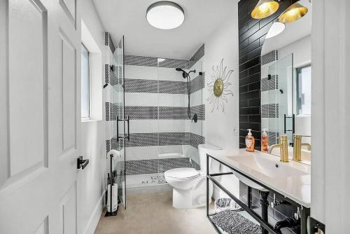 a bathroom with a toilet and a sink and a shower at 8000sf 7BR Villa Casita Pool Spa Gym & Games in Las Vegas