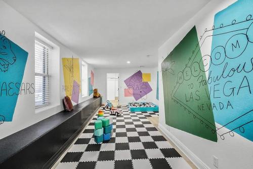 a room with a checkered floor and paintings on the walls at 8000sf 7BR Villa Casita Pool Spa Gym & Games in Las Vegas