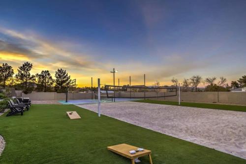a tennis court with a table on the grass at 8000sf 7BR Villa Casita Pool Spa Gym & Games in Las Vegas