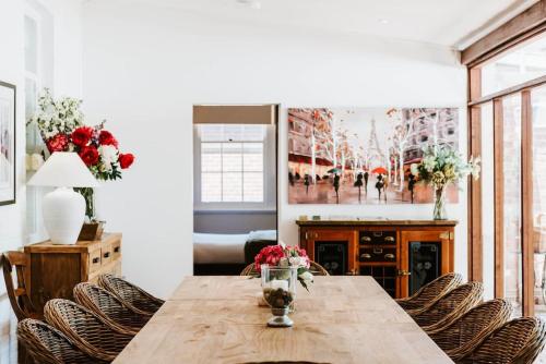 a dining room with a wooden table and chairs at Cawarra on the Park - Historic Mudgee Grandeur in Mudgee