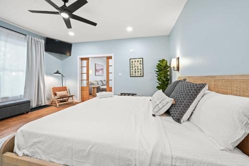 a bedroom with a large bed with a ceiling fan at Bungalow on Main - Near Ark in Williamstown