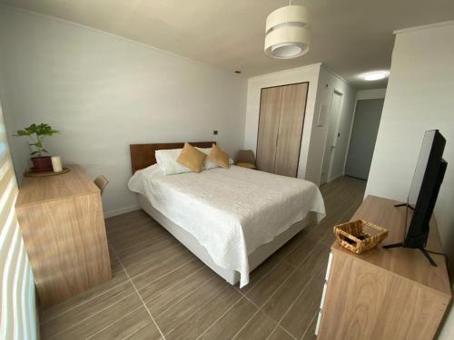 En eller flere senge i et værelse på Departamento Studio Isla Teja