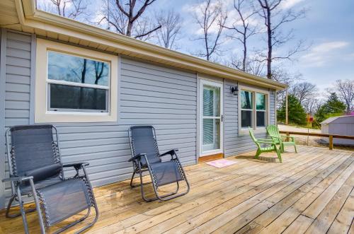 a deck with three chairs and a house at Dock and Furnished Deck Lakefront Gravois Mills Gem in Gravois Mills
