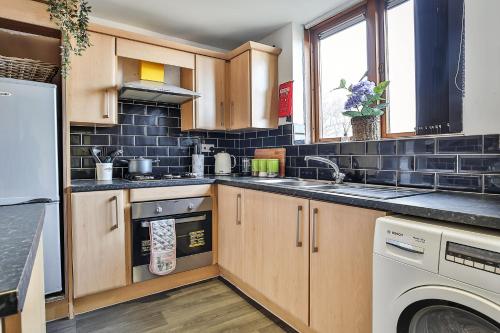 a kitchen with a sink and a dishwasher at George House - 3BSleep9 Close to Train station,Uni,Pond Forge,City Centre,Free Parking in Sheffield