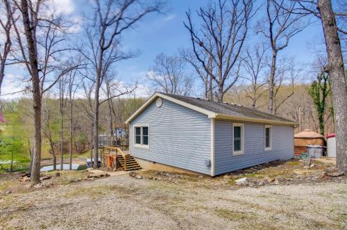 a small house in the middle of a yard at Dock and Furnished Deck Lakefront Gravois Mills Gem in Gravois Mills
