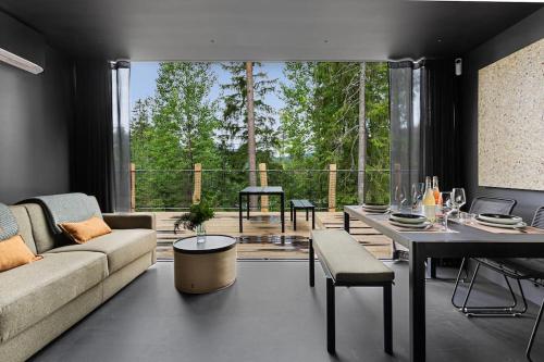 a living room with a couch and a table at Unique Modern Cabin with Views 