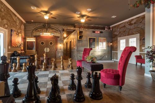 a room with a giant chess board and chairs at 10 Acre Lakefront Game House - Sleep Upto 45 in Clermont