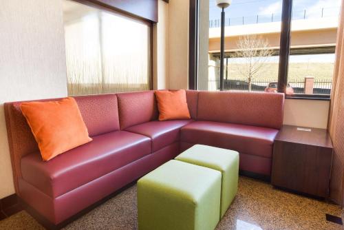 a leather couch in a waiting room with an ottoman at Drury Inn & Suites Denver Tech Center in Centennial