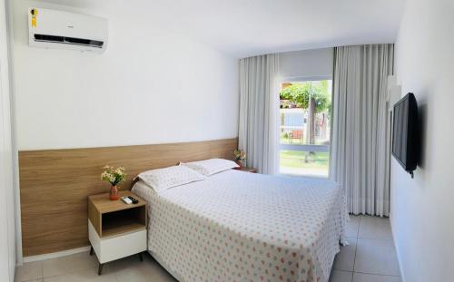 Un pat sau paturi într-o cameră la Condomínio Porto Smeralda