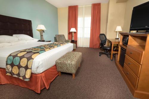 a hotel room with a large bed and a desk at Drury Plaza Hotel San Antonio North Stone Oak in San Antonio