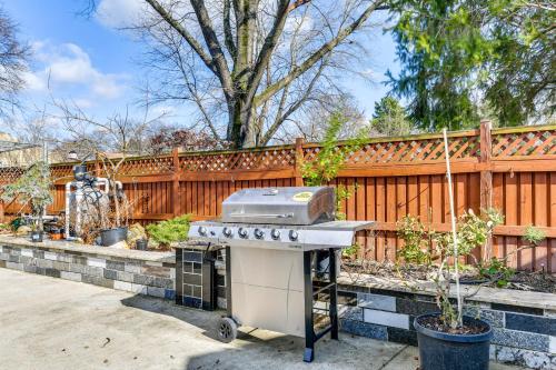 a barbecue grill in a backyard with a fence at Spacious Home with Tranquil Patio about 29 Mi to DC! in Severn