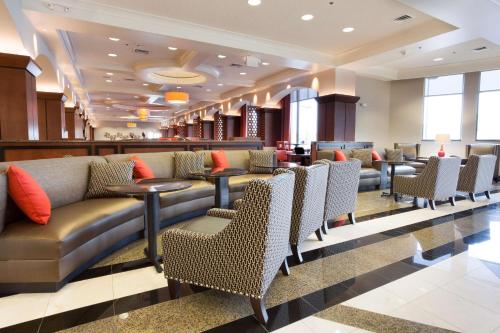 a lobby of a hotel with couches and chairs at Drury Plaza Hotel Indianapolis Carmel in Indianapolis