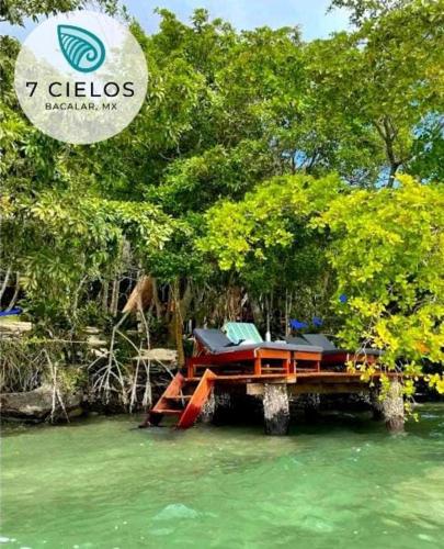 a dock with chairs sitting on top of the water at 7 CIELOS BACALAR. in Bacalar