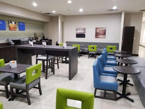 a dining room with tables and chairs in a restaurant at SureStay Plus by Best Western Corydon in Corydon