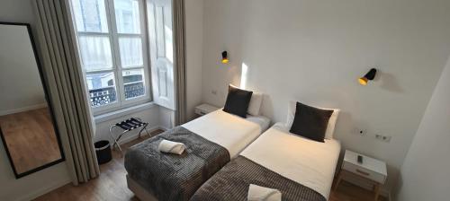 a living room with a couch and a window at Correio Velho Suites in Lisbon