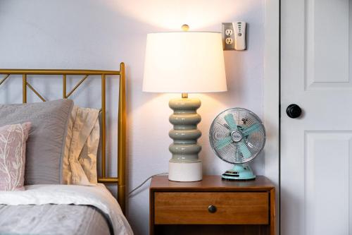 a lamp on a night stand next to a bed at French Island Whot Tub, Kayak, Lake View, Ev in La Crosse