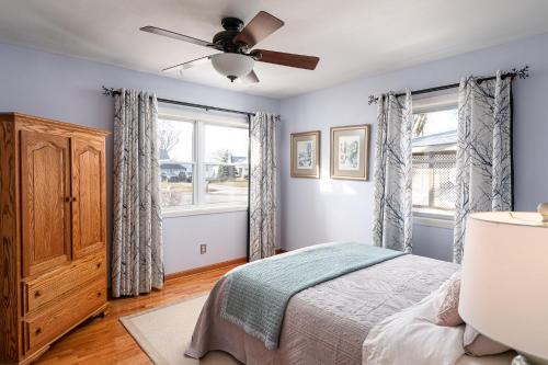 a bedroom with a bed and a ceiling fan at French Island Whot Tub, Kayak, Lake View, Ev in La Crosse