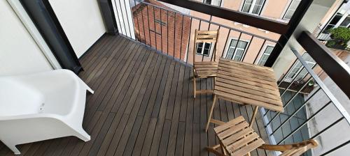 an overhead view of a wooden deck with a chair at Correio Velho Suites in Lisbon