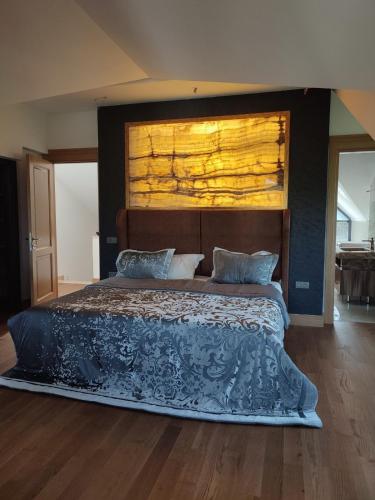 a bedroom with a large bed with a wooden headboard at Luxury villa in Istanbul