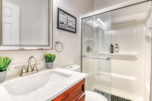 a white bathroom with a sink and a shower at Modern 3BR2BA Apartment Minutes to NYC in Jersey City