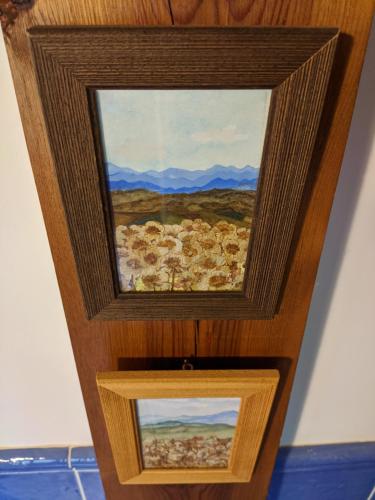 two paintings on the wall of a bathroom at Casa Maite in Ríoseco de Soria