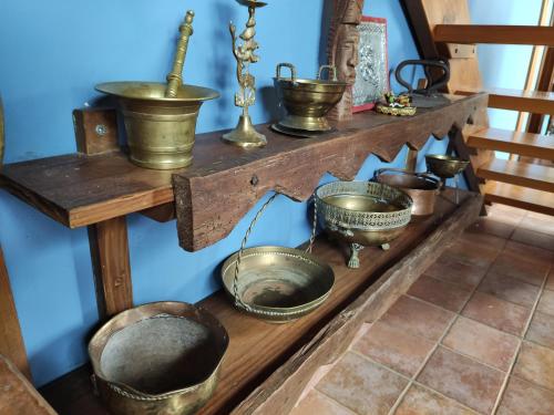 a shelf with copper pots and pans on it at Casa Maite in Ríoseco de Soria
