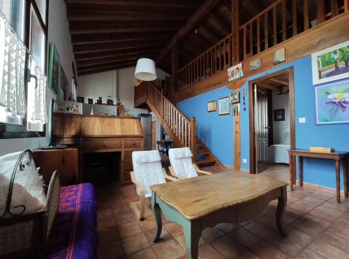 a dining room with a wooden table and chairs at Casa Maite in Ríoseco de Soria