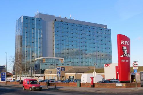 a red van parked in front of a large building at Two bed Apartment free parking near Colindale Station in Colindale