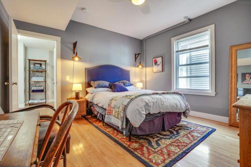 a bedroom with a bed and a table and chairs at Pet-Friendly Saint Paul Vacation Rental with Deck! in West Saint Paul