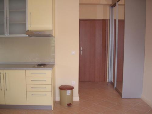 a kitchen with white cabinets and a trash can at Apartments Villa Astra & Pinija in Brela