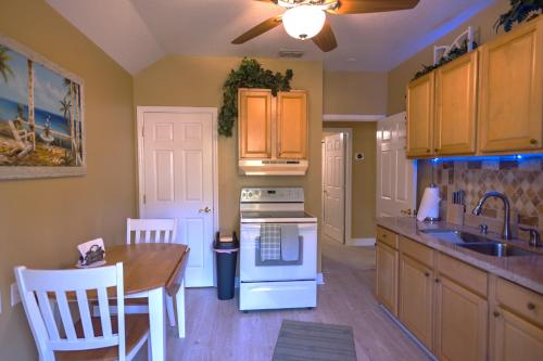 a kitchen with a table and a stove top oven at Paradise in a country setting 1100 sq ft apartment in Lake Mary