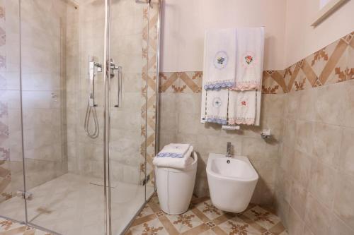 a bathroom with a shower and a toilet and a sink at Antica Colombaia in San Marino