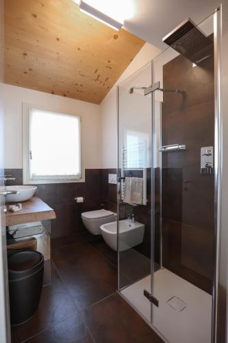 a bathroom with a shower and a toilet and a sink at Antica Colombaia in San Marino