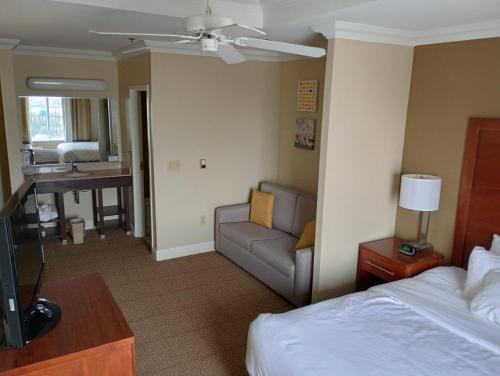 a hotel room with a bed and a couch at SAMIR Stay at NW Expressway in Oklahoma City