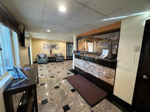 a lobby with a waiting room with a reception desk at Eco-Lux Inn Norfolk in Norfolk