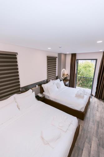 a bedroom with two beds and a window at VIN HOTEL in Vĩnh Long