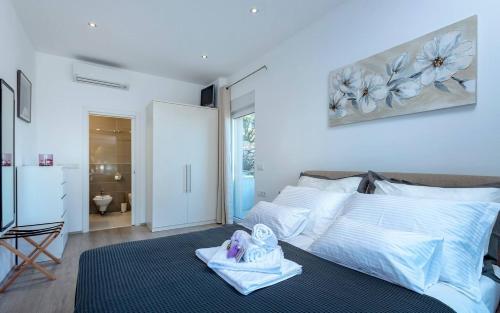 a bedroom with a large bed with towels on it at Holiday house with a swimming pool Hvar - 22428 in Hvar