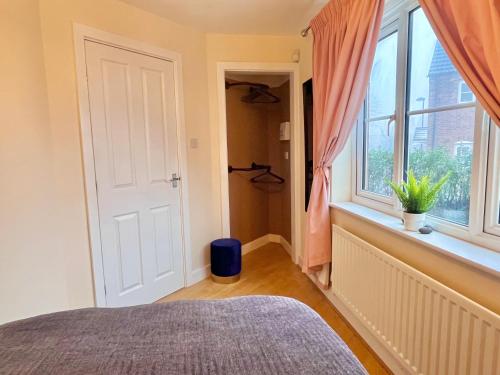 a bedroom with a bed and a window at Payler House Sheffield-WiFi -Large Parking Space-cozy 4 bedrooms in Sheffield