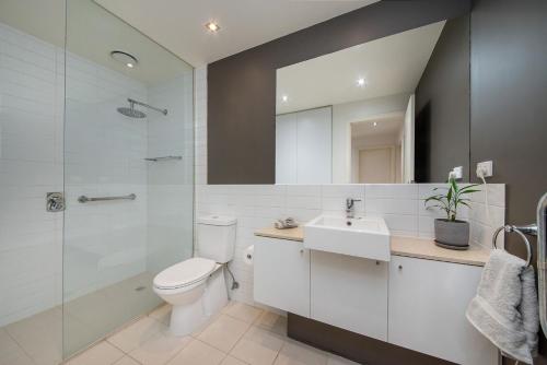 a bathroom with a toilet and a sink and a shower at Heart of Hampton by the Beach in Melbourne
